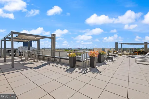 a view of a patio with dining table and chairs with plants