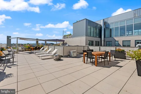 a view of a patio with a table and chairs