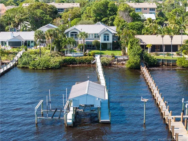 an aerial view of a house with wooden floor lake view and boat