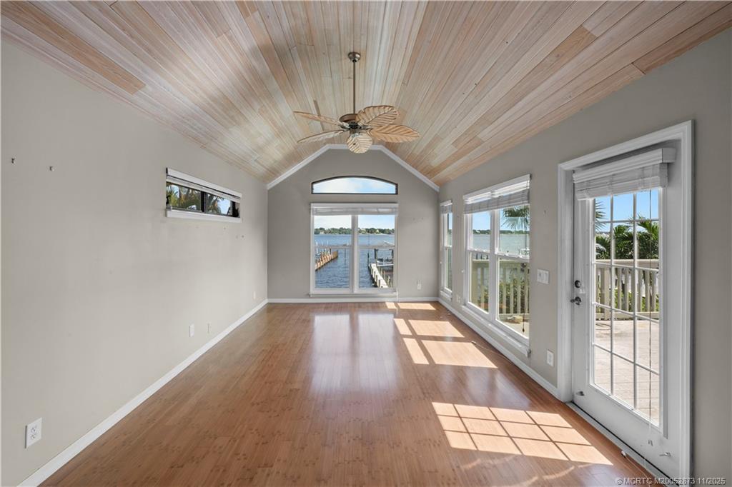 969 Southeast St Lucie Boulevard Stuart, FL 34996 - Photo 12 of 49 a view of a hallway with wooden floor and a chandelier