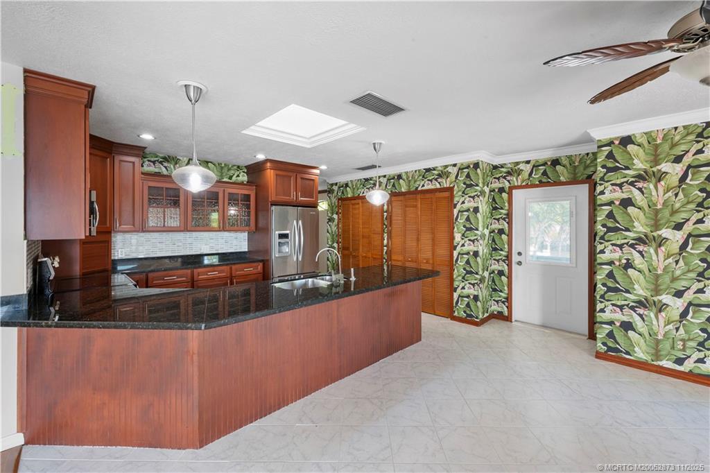969 Southeast St Lucie Boulevard Stuart, FL 34996 - Photo 15 of 49 a large kitchen with stainless steel appliances wooden floor and a large window