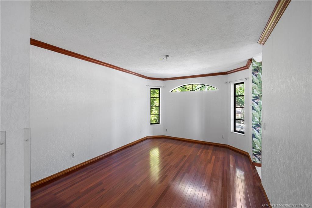 969 Southeast St Lucie Boulevard Stuart, FL 34996 - Photo 16 of 49 wooden floor in an empty room with a window