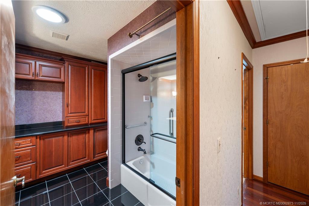 969 Southeast St Lucie Boulevard Stuart, FL 34996 - Photo 18 of 49 a bathroom with a tub and shower