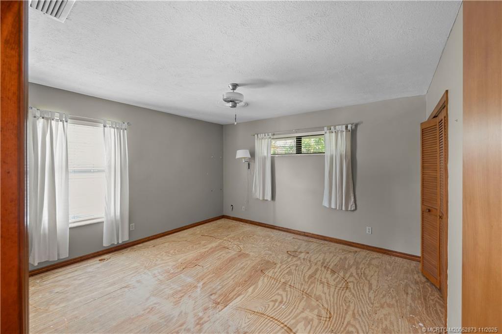 969 Southeast St Lucie Boulevard Stuart, FL 34996 - Photo 21 of 49 a view of an empty room with chandelier and window