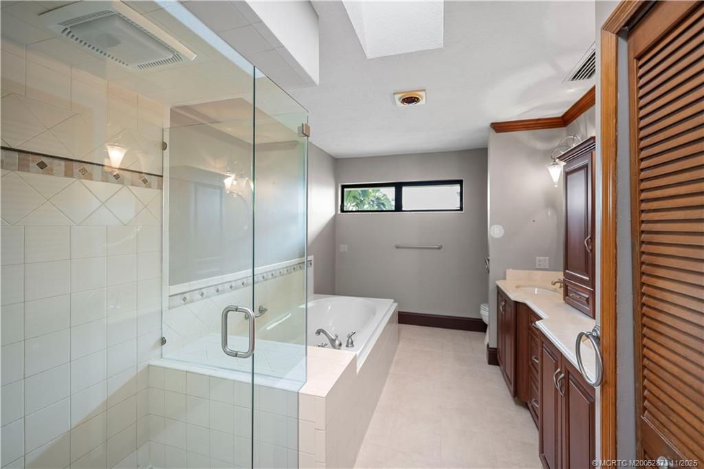 969 Southeast St Lucie Boulevard Stuart, FL 34996 - Photo 25 of 49 a bathroom with a bathtub and a shower