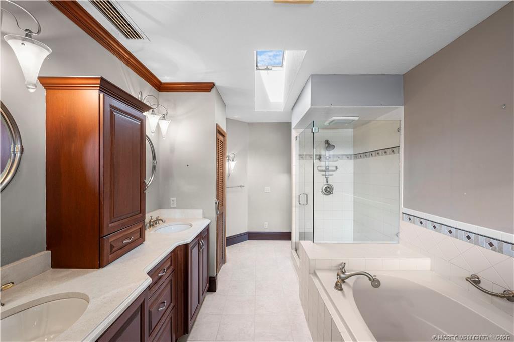 969 Southeast St Lucie Boulevard Stuart, FL 34996 - Photo 28 of 49 a bathroom with a tub sink and mirror