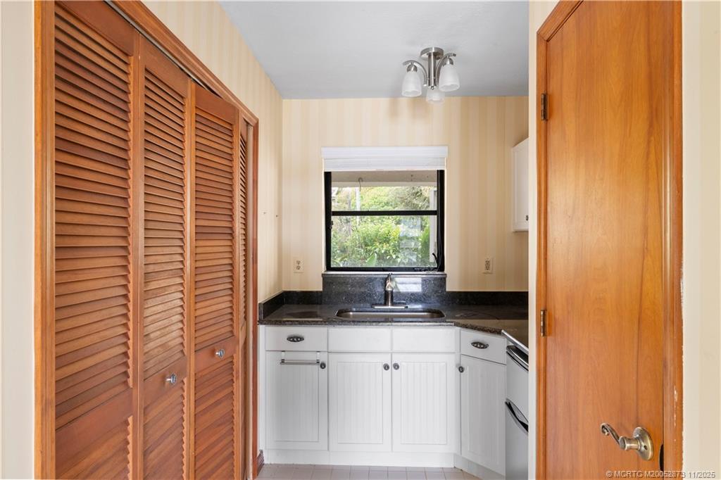 969 Southeast St Lucie Boulevard Stuart, FL 34996 - Photo 33 of 49 a bathroom with a granite countertop sink and window