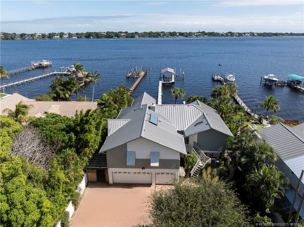 969 Southeast St Lucie Boulevard Stuart, FL 34996 - Photo 48 of 49 an aerial view of a house with outdoor space and lake view