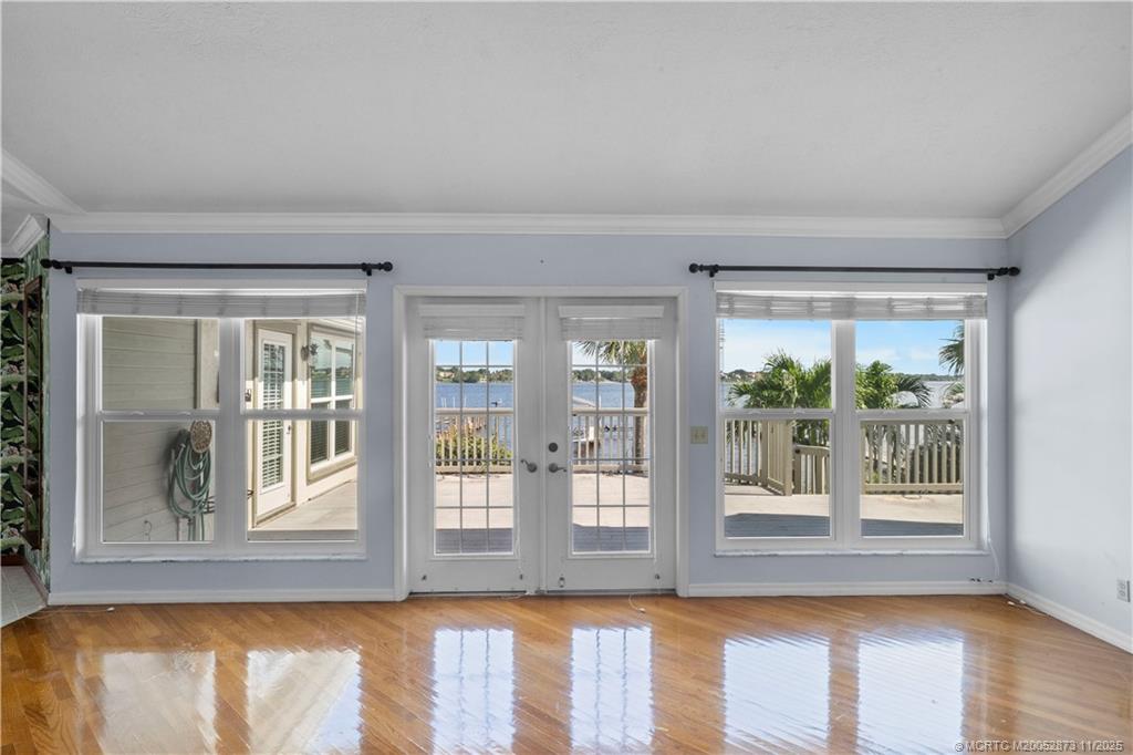 969 Southeast St Lucie Boulevard Stuart, FL 34996 - Photo 9 of 49 a view of wooden floor and windows in a room