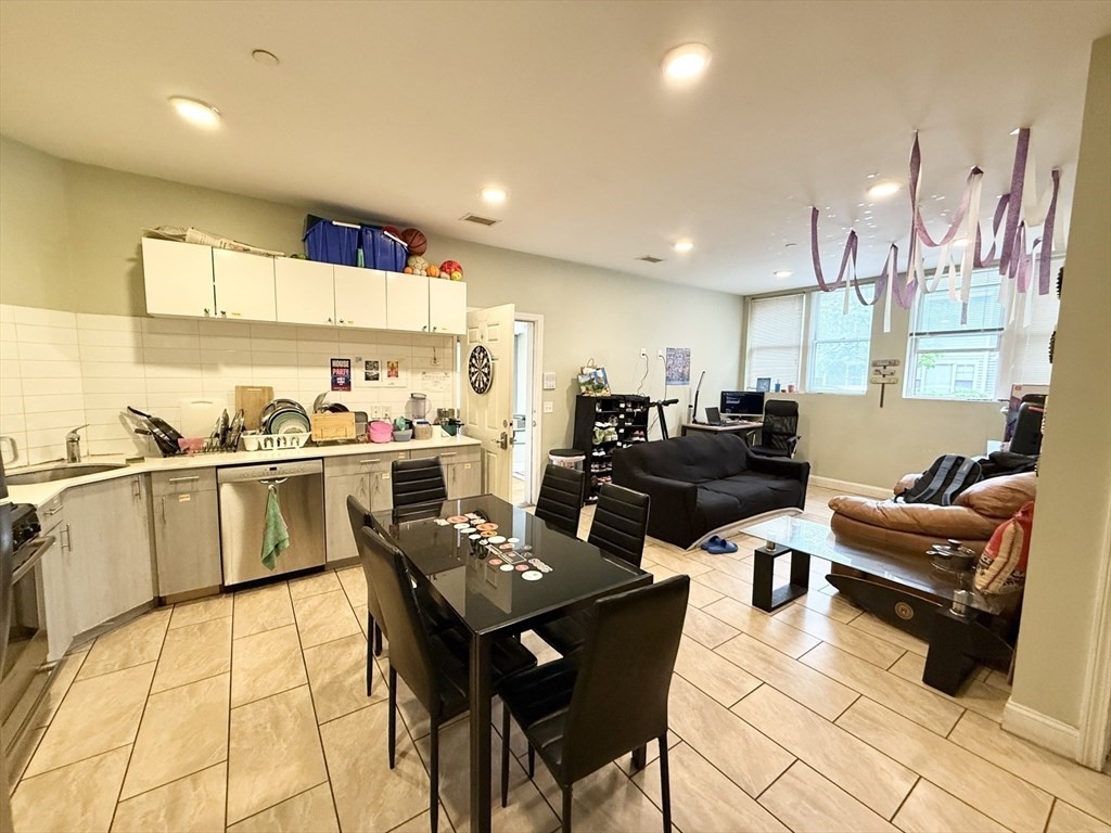 299 Dudley Street, Unit 2 Boston, MA 02119 - Photo 1 of 6 a living room with lots of furniture and kitchen view