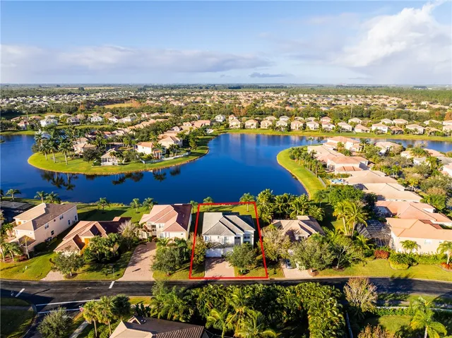 an aerial view of a residential building and ocean view