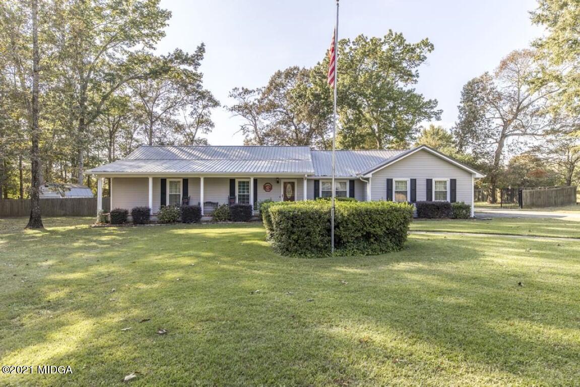 a front view of a house with a yard and porch