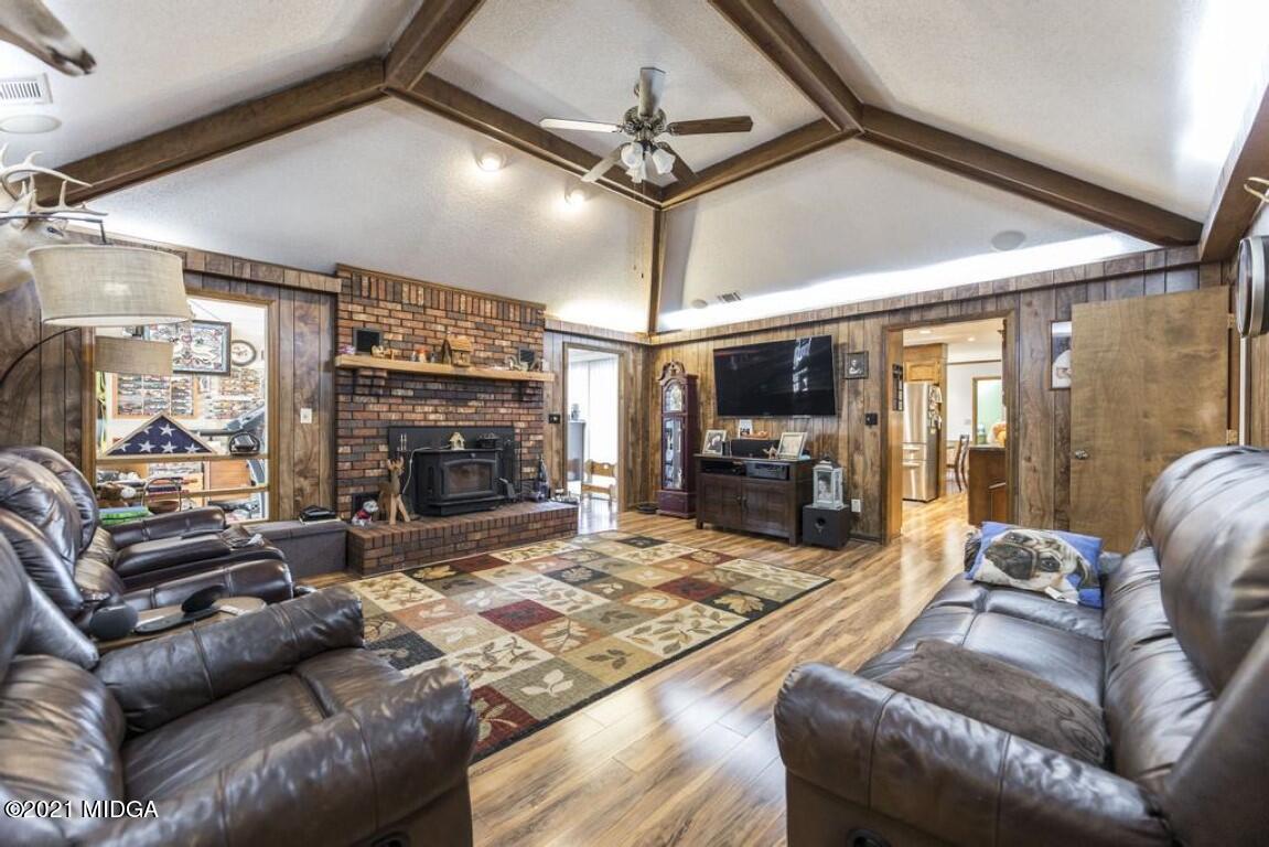 1471 Woolfolk Road Fort Valley, GA 31030 - Photo 13 of 51 a living room with furniture fireplace and a flat screen tv