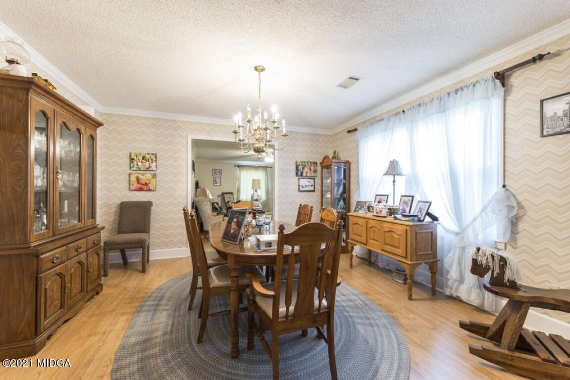 1471 Woolfolk Road Fort Valley, GA 31030 - Photo 17 of 51 a view of a dining room with furniture window and wooden floor