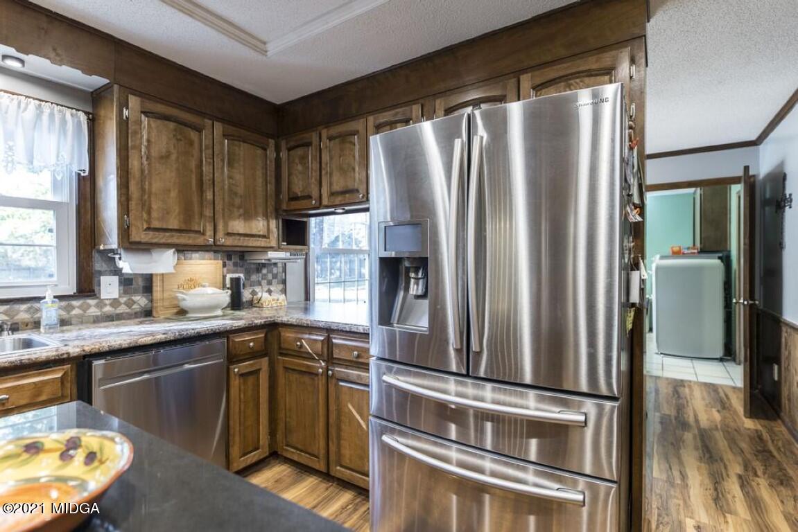 1471 Woolfolk Road Fort Valley, GA 31030 - Photo 24 of 51 a kitchen with stainless steel appliances granite countertop a refrigerator a sink a stove and island