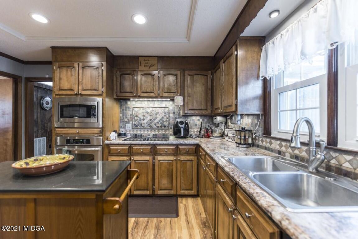 1471 Woolfolk Road Fort Valley, GA 31030 - Photo 26 of 51 a kitchen with a sink stove and cabinets
