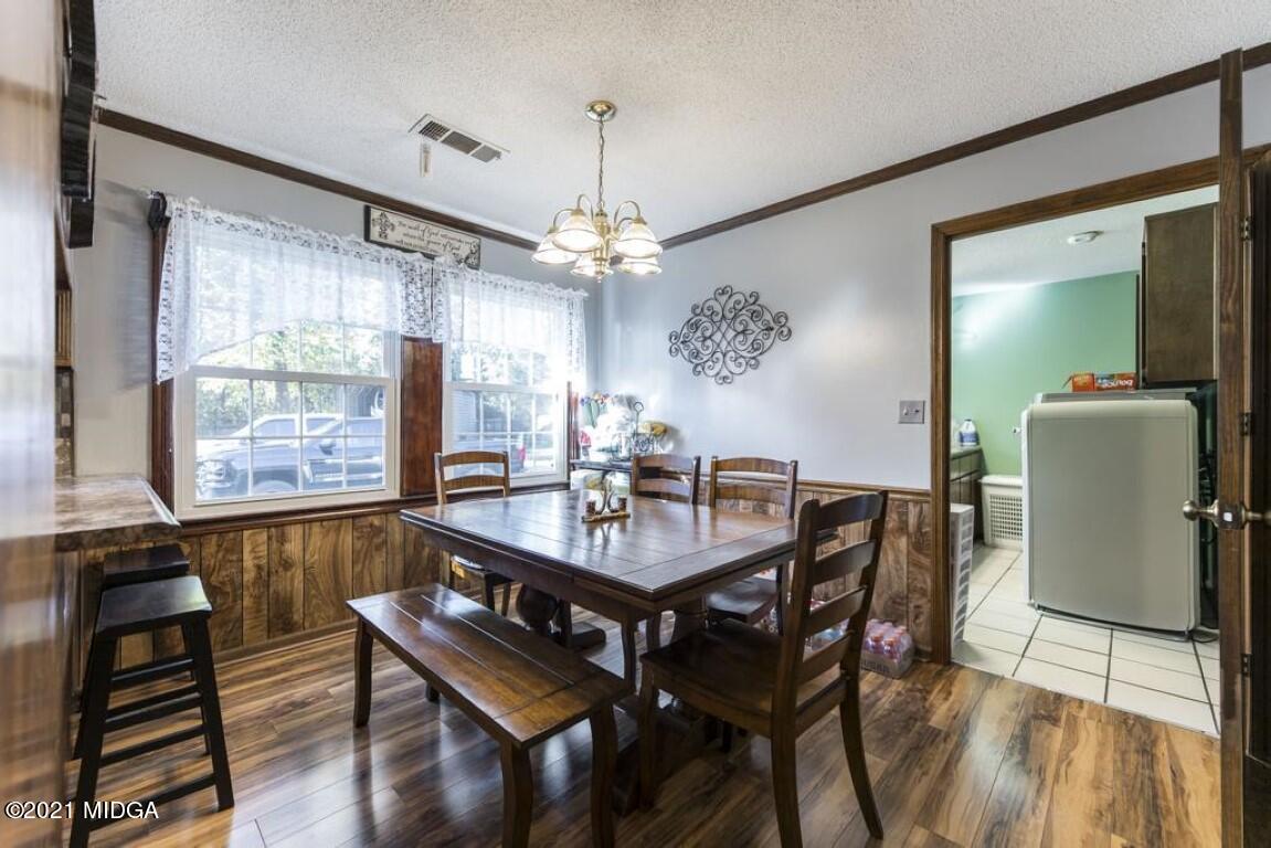 1471 Woolfolk Road Fort Valley, GA 31030 - Photo 27 of 51 a view of a dining room with furniture window and wooden floor