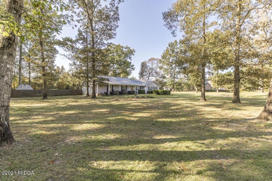 1471 Woolfolk Road Fort Valley, GA 31030 - Photo 4 of 51 a view of a swimming pool with an outdoor space and seating area
