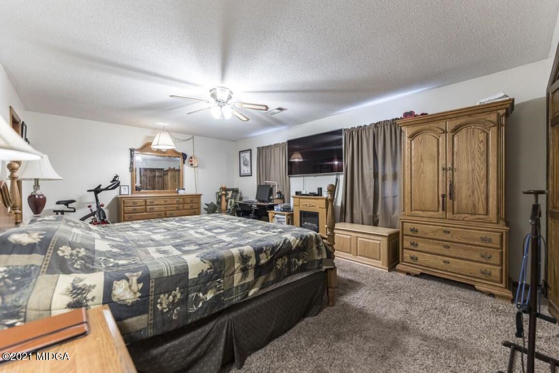 1471 Woolfolk Road Fort Valley, GA 31030 - Photo 35 of 51 a spacious bedroom with a bed and furniture
