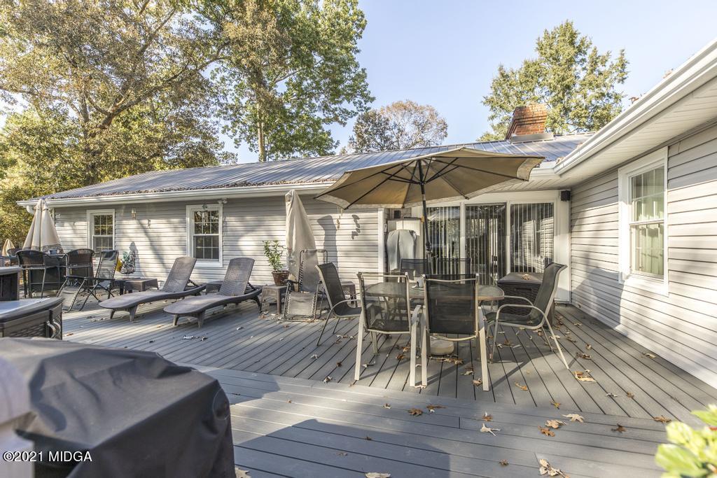 1471 Woolfolk Road Fort Valley, GA 31030 - Photo 42 of 51 a patio with wooden table and chairs