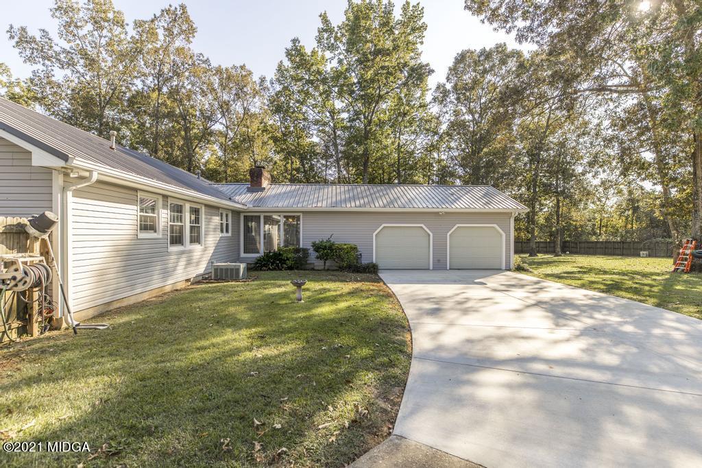 1471 Woolfolk Road Fort Valley, GA 31030 - Photo 46 of 51 a front view of a house with a yard and garage