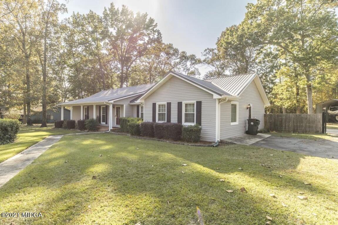 1471 Woolfolk Road Fort Valley, GA 31030 - Photo 9 of 51 a view of a yard in front of a house with a large tree