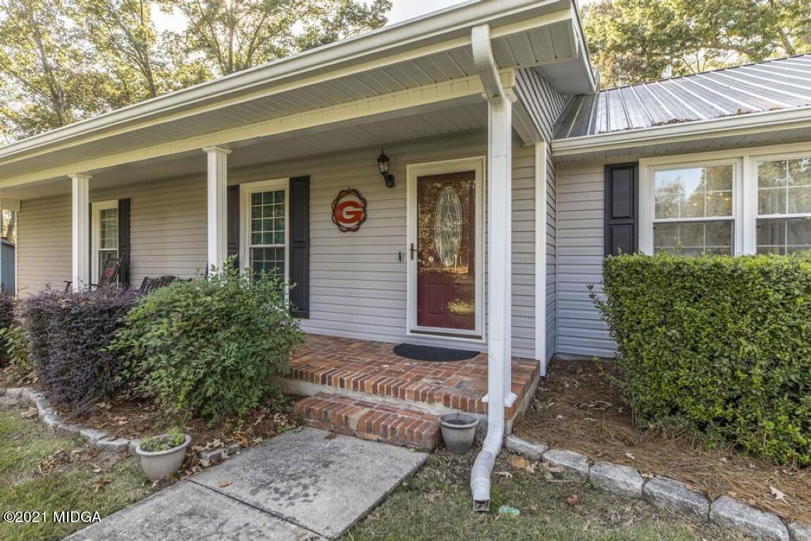 1471 Woolfolk Road Fort Valley, GA 31030 - Photo 10 of 51 front view of a house with potted plants
