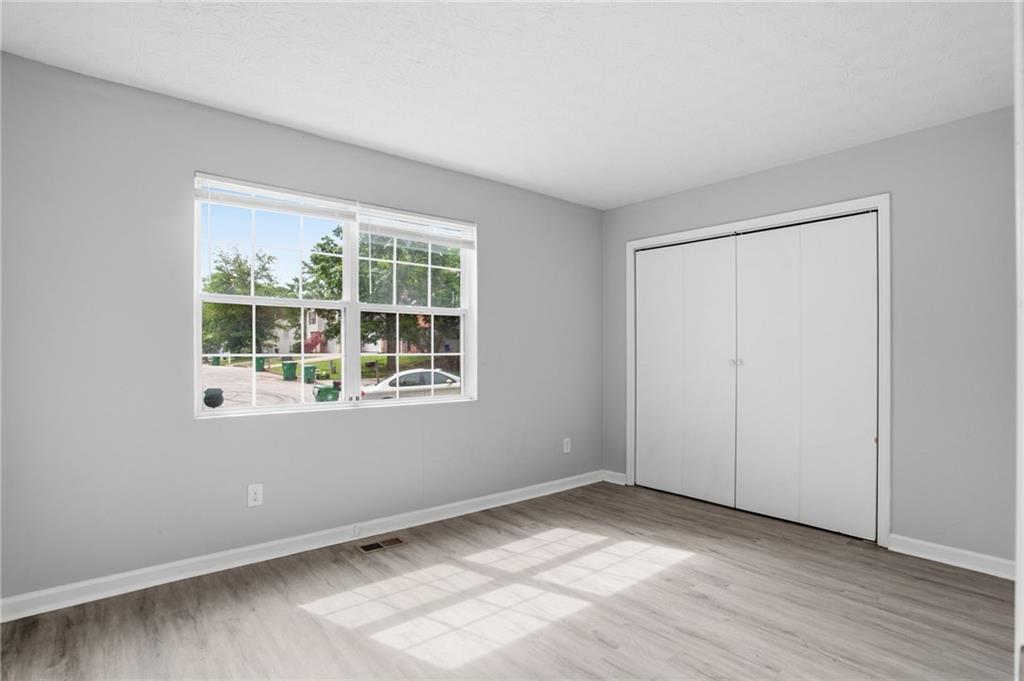 5855 Crescent Ridge Court Lithonia, GA 30058 - Photo 26 of 46 an empty room with wooden floor and windows