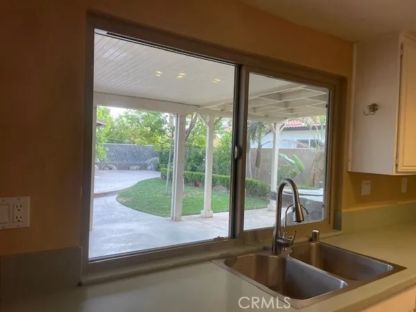 a kitchen with a sink and a large window