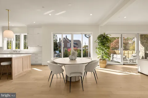 a dining room with furniture a chandelier and wooden floor