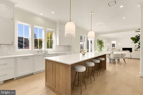 a kitchen with center island table and chairs in it