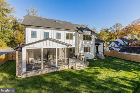 a kitchen with a sink chandelier and living room view