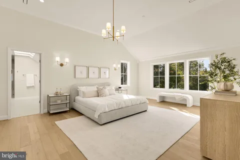 a bedroom with bed tv and a window