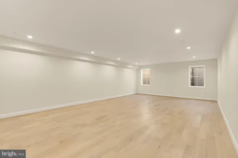 a view of empty room with a kitchen