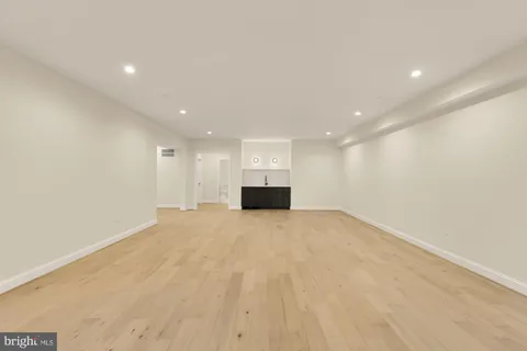 a bathroom with a double vanity sink a mirror and a bathtub