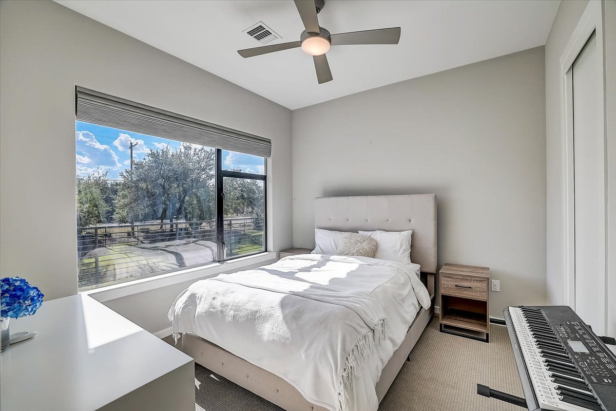 5921 Hiline Road, Unit 1204 Austin, TX 78734 - Photo 18 of 36 Carpeted bedroom with a ceiling fan