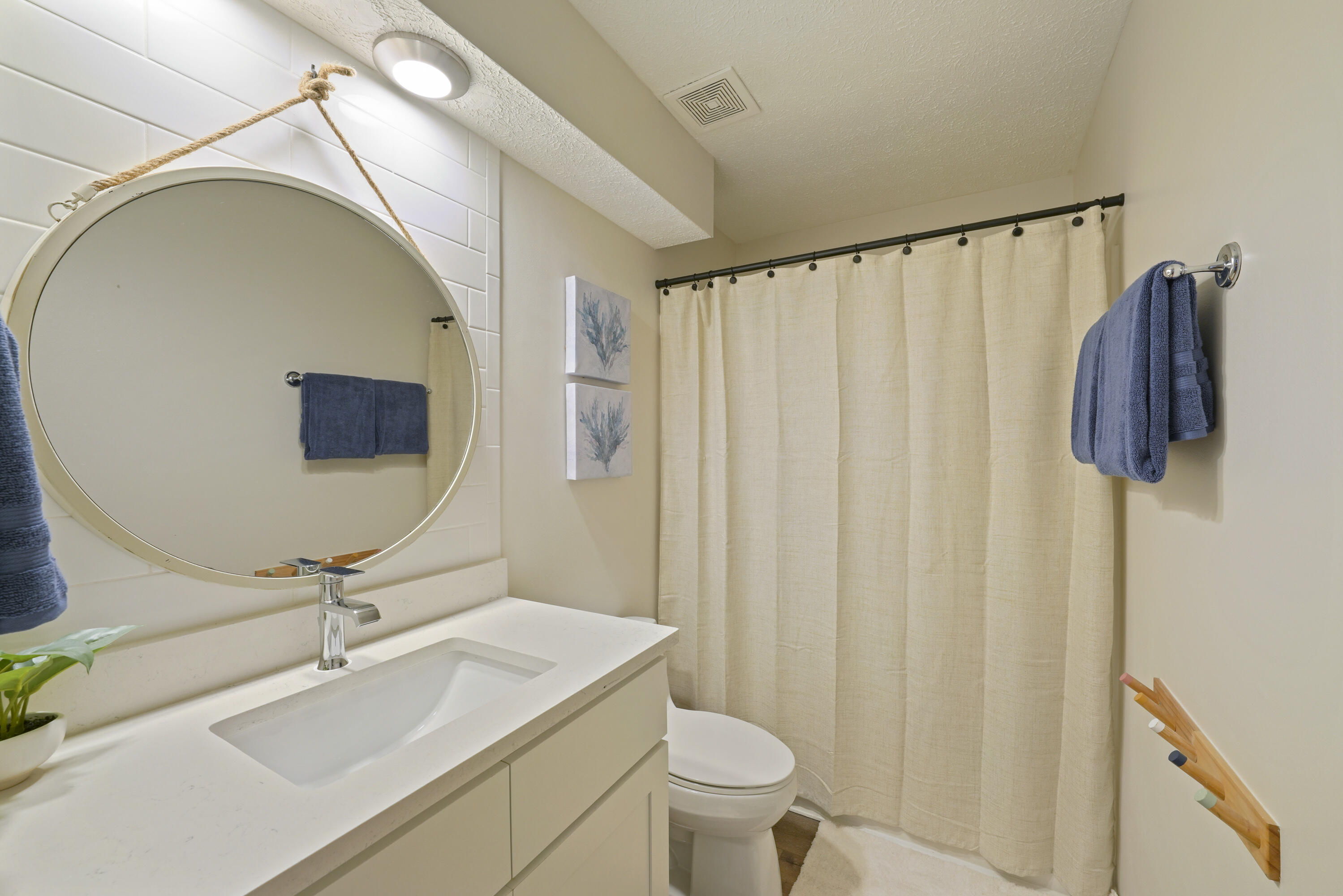 17670 Front Beach Road, Unit H9 Panama City Beach, FL 32413 - Photo 12 of 31 a bathroom with a sink toilet and mirror