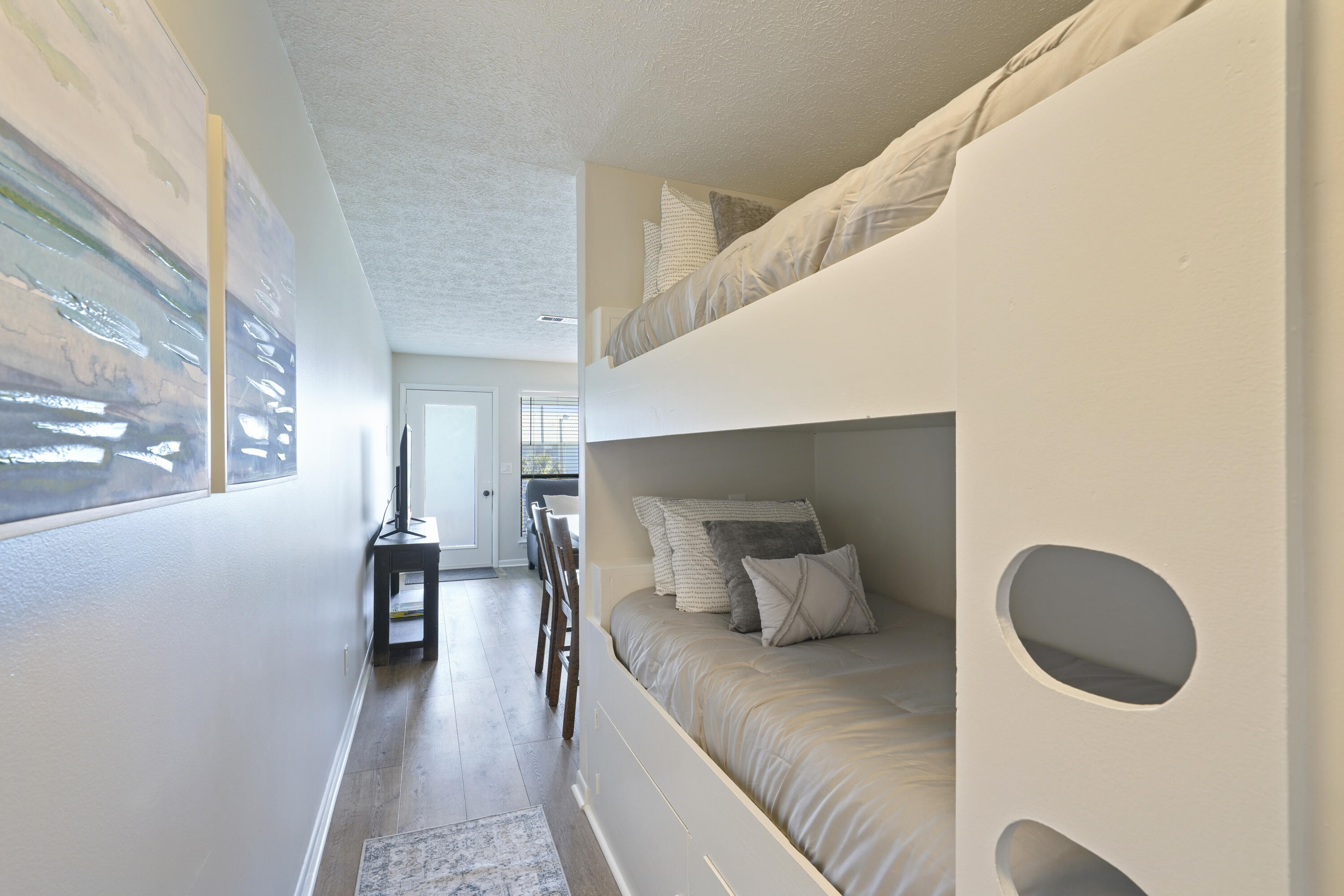 17670 Front Beach Road, Unit H9 Panama City Beach, FL 32413 - Photo 13 of 31 a bedroom with a bed and chair