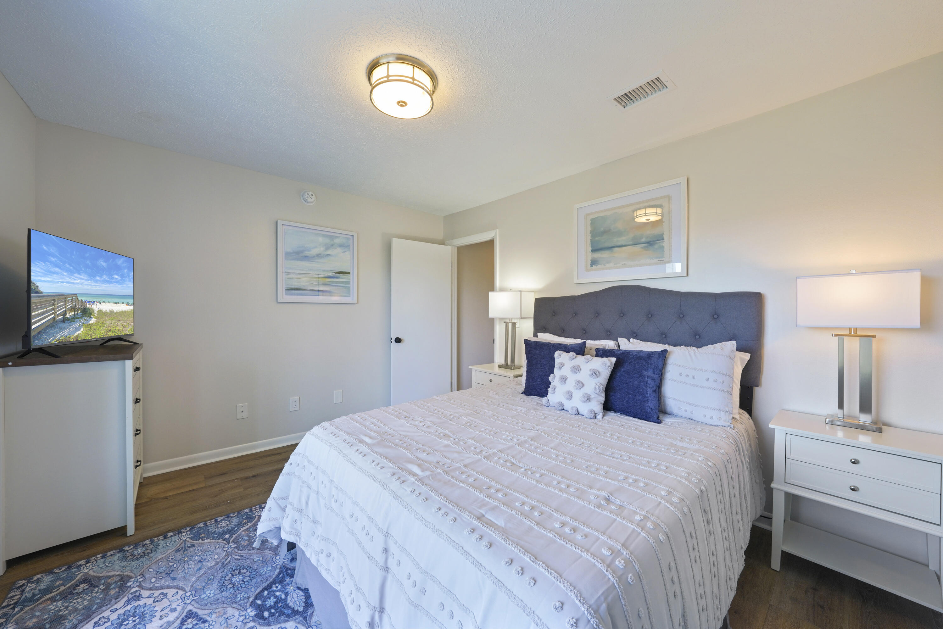 17670 Front Beach Road, Unit H9 Panama City Beach, FL 32413 - Photo 15 of 31 a bedroom with a bed and a lamp on dresser