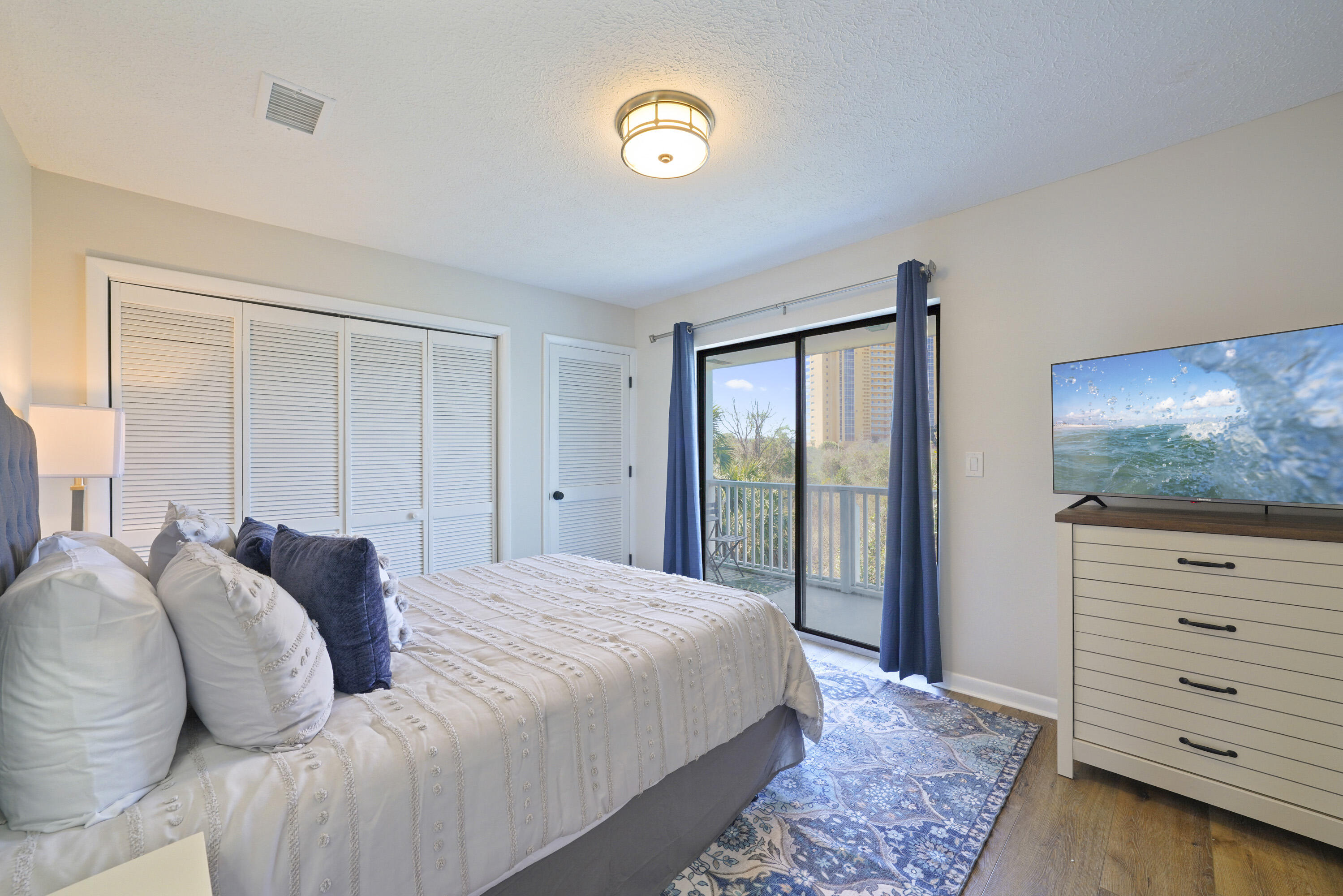 17670 Front Beach Road, Unit H9 Panama City Beach, FL 32413 - Photo 16 of 31 a bed room with a bed and a television