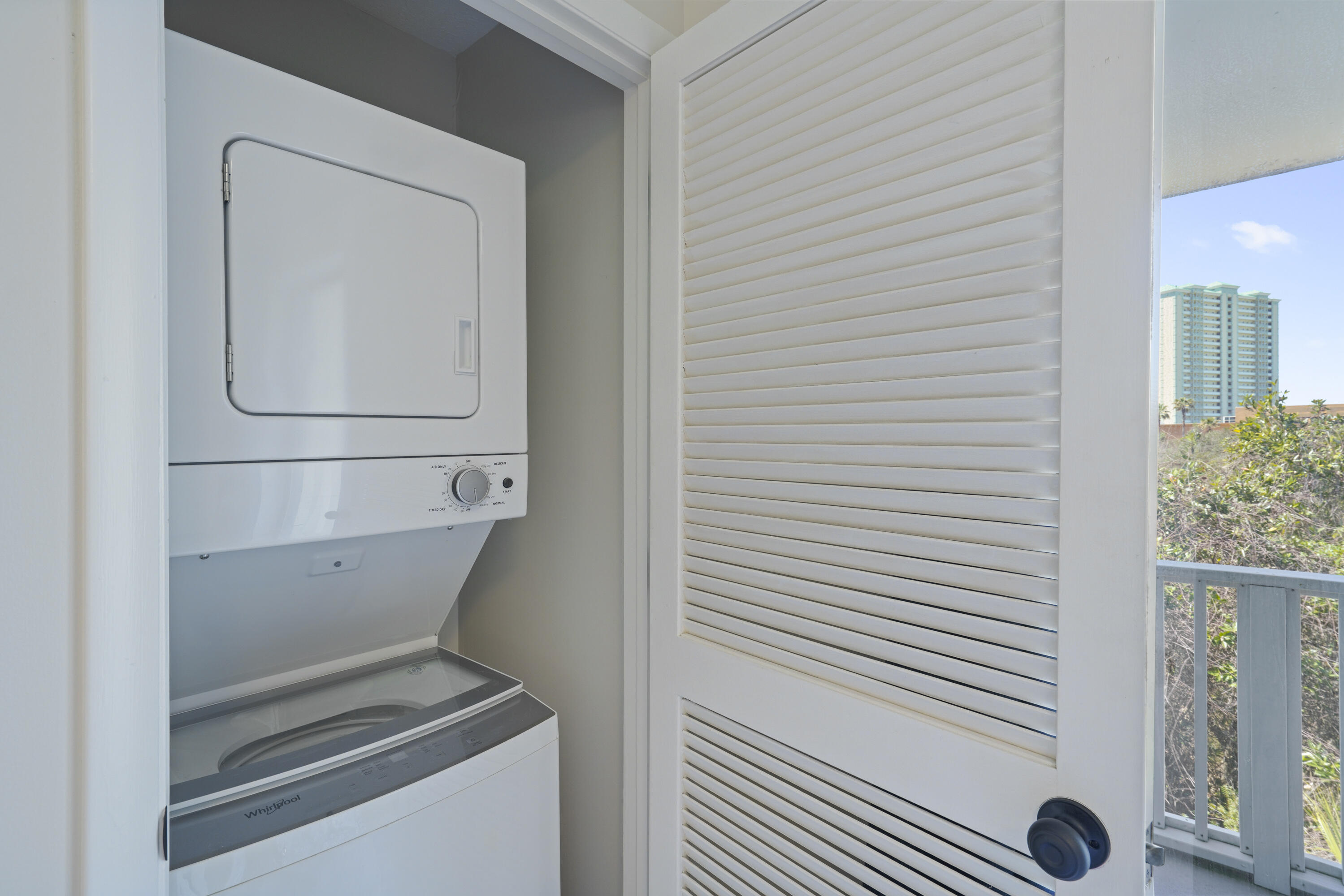 17670 Front Beach Road, Unit H9 Panama City Beach, FL 32413 - Photo 18 of 31 a utility room with dryer and washer