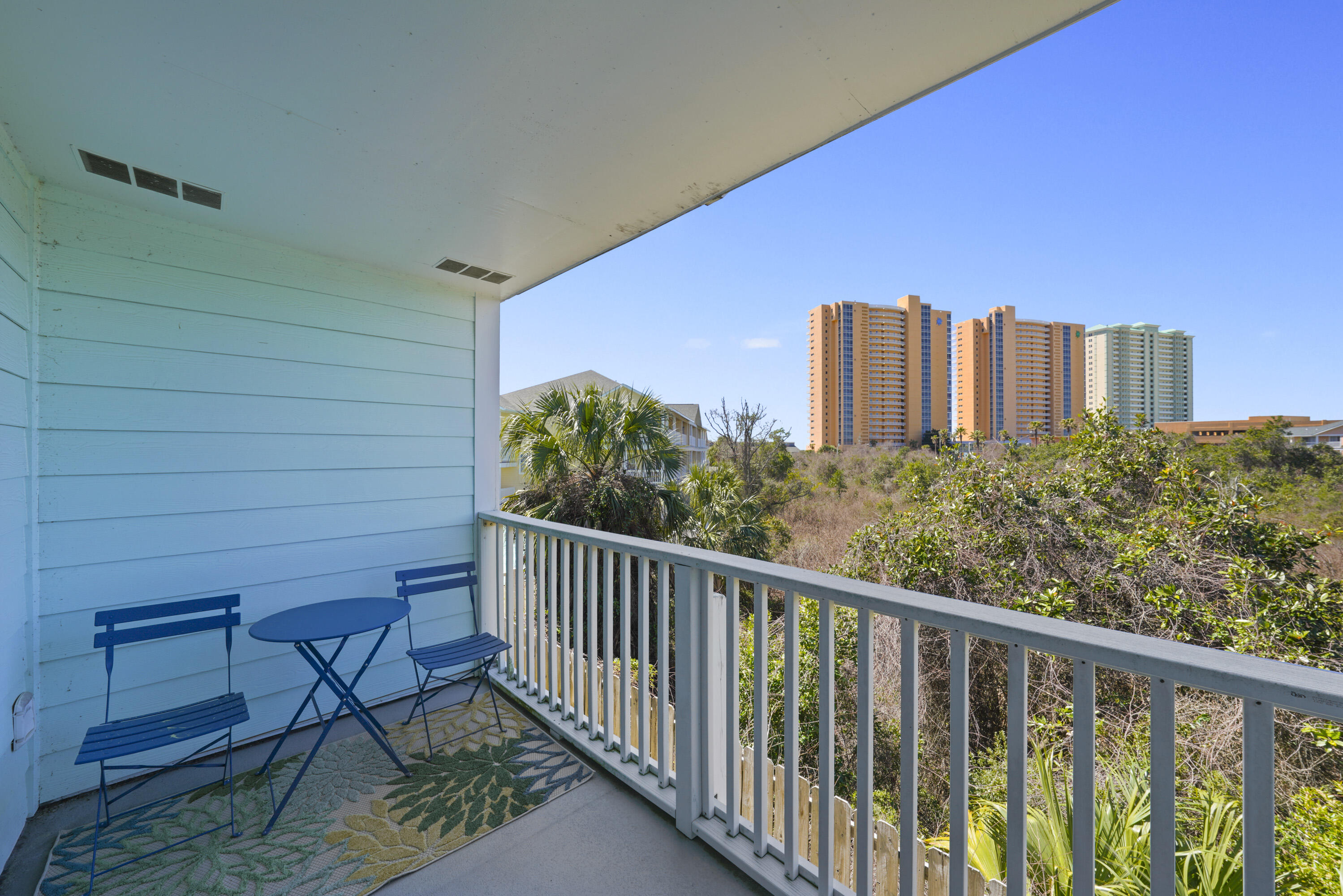 17670 Front Beach Road, Unit H9 Panama City Beach, FL 32413 - Photo 19 of 31 a view of a balcony with furniture and wooden floor
