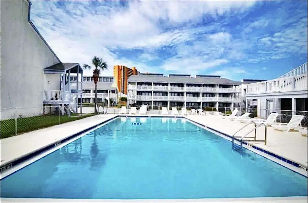 17670 Front Beach Road, Unit H9 Panama City Beach, FL 32413 - Photo 21 of 31 a view of a swimming pool with a patio