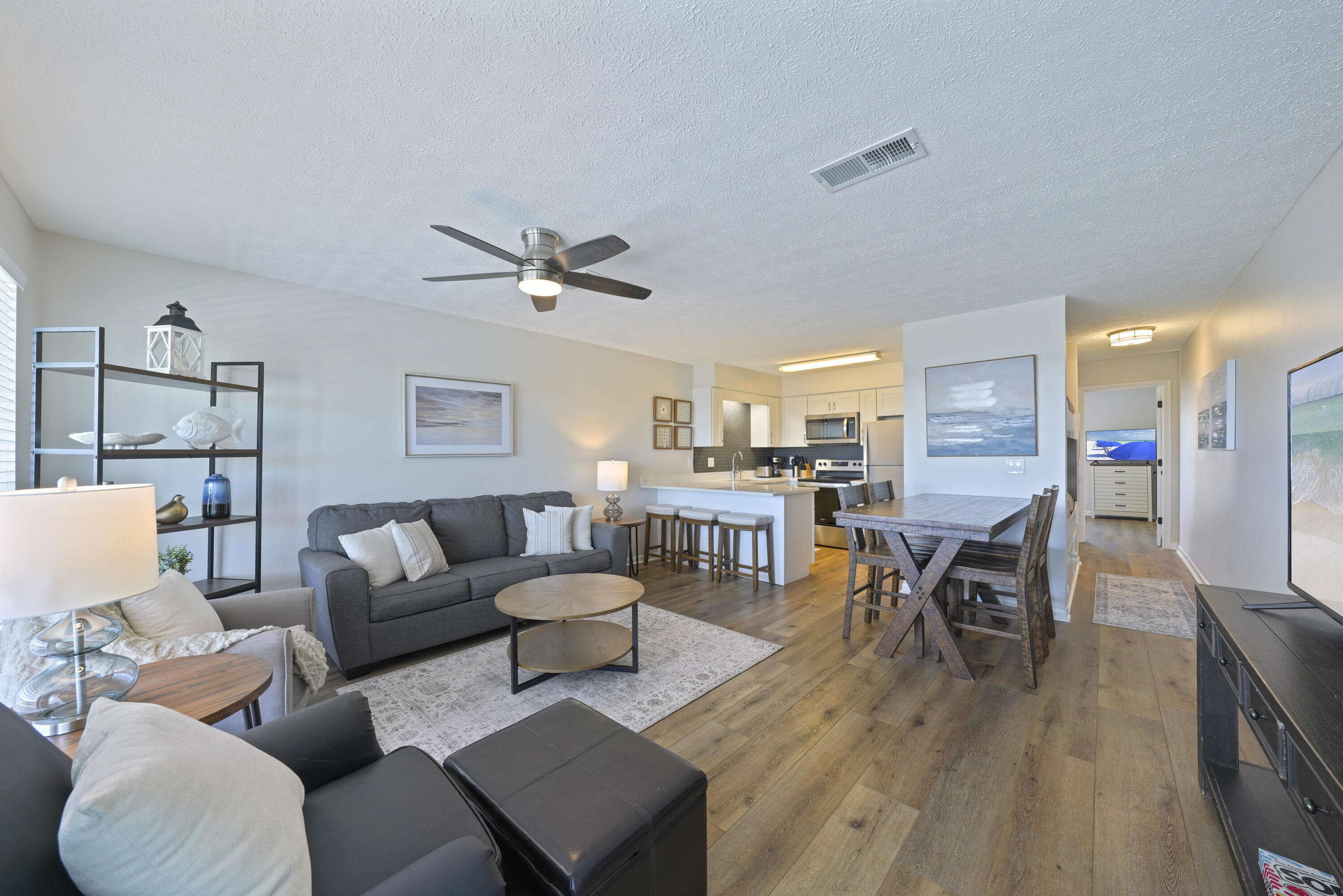 17670 Front Beach Road, Unit H9 Panama City Beach, FL 32413 - Photo 4 of 31 a living room with furniture and a wooden floor