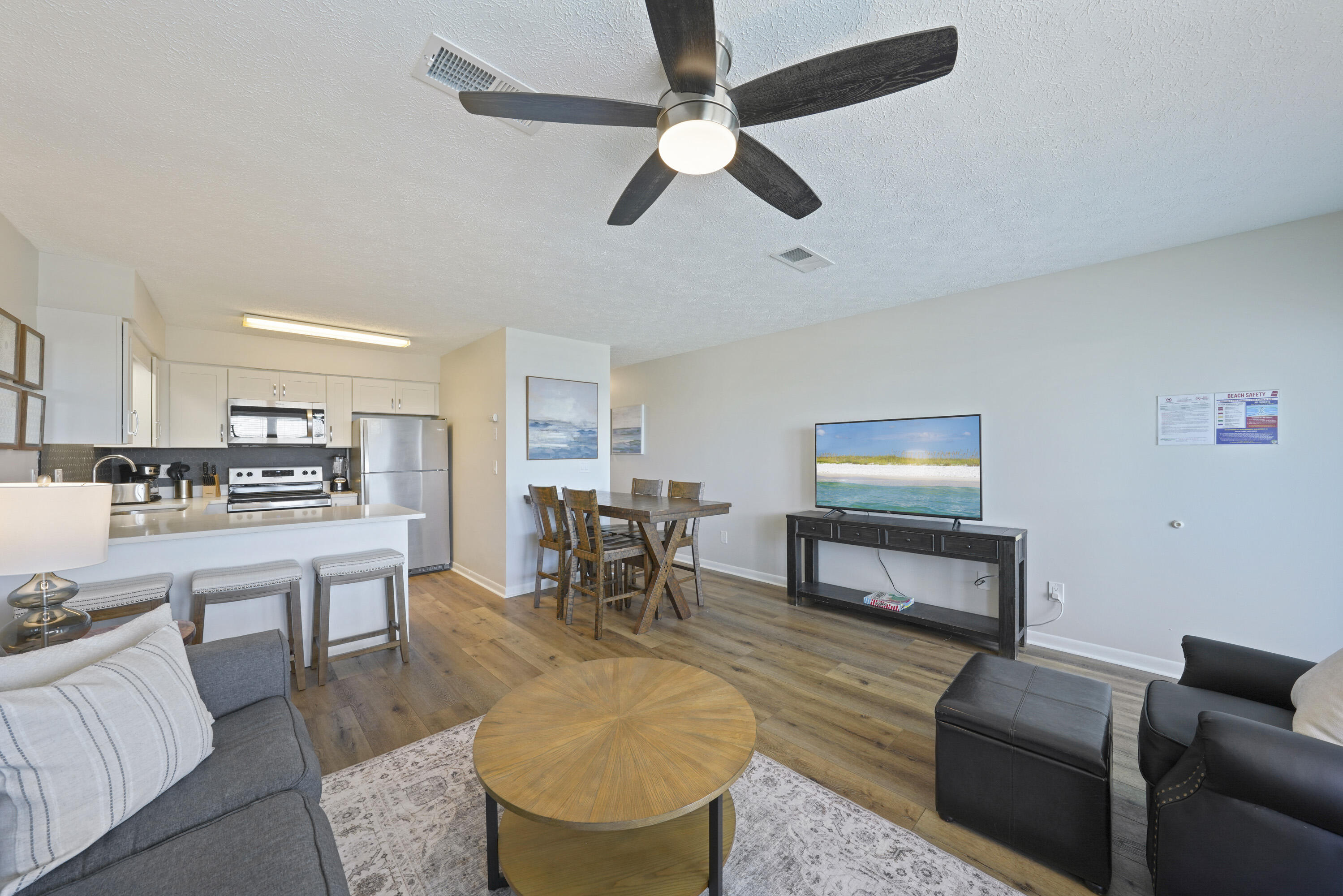 17670 Front Beach Road, Unit H9 Panama City Beach, FL 32413 - Photo 6 of 31 a living room with furniture kitchen view and a wooden floor
