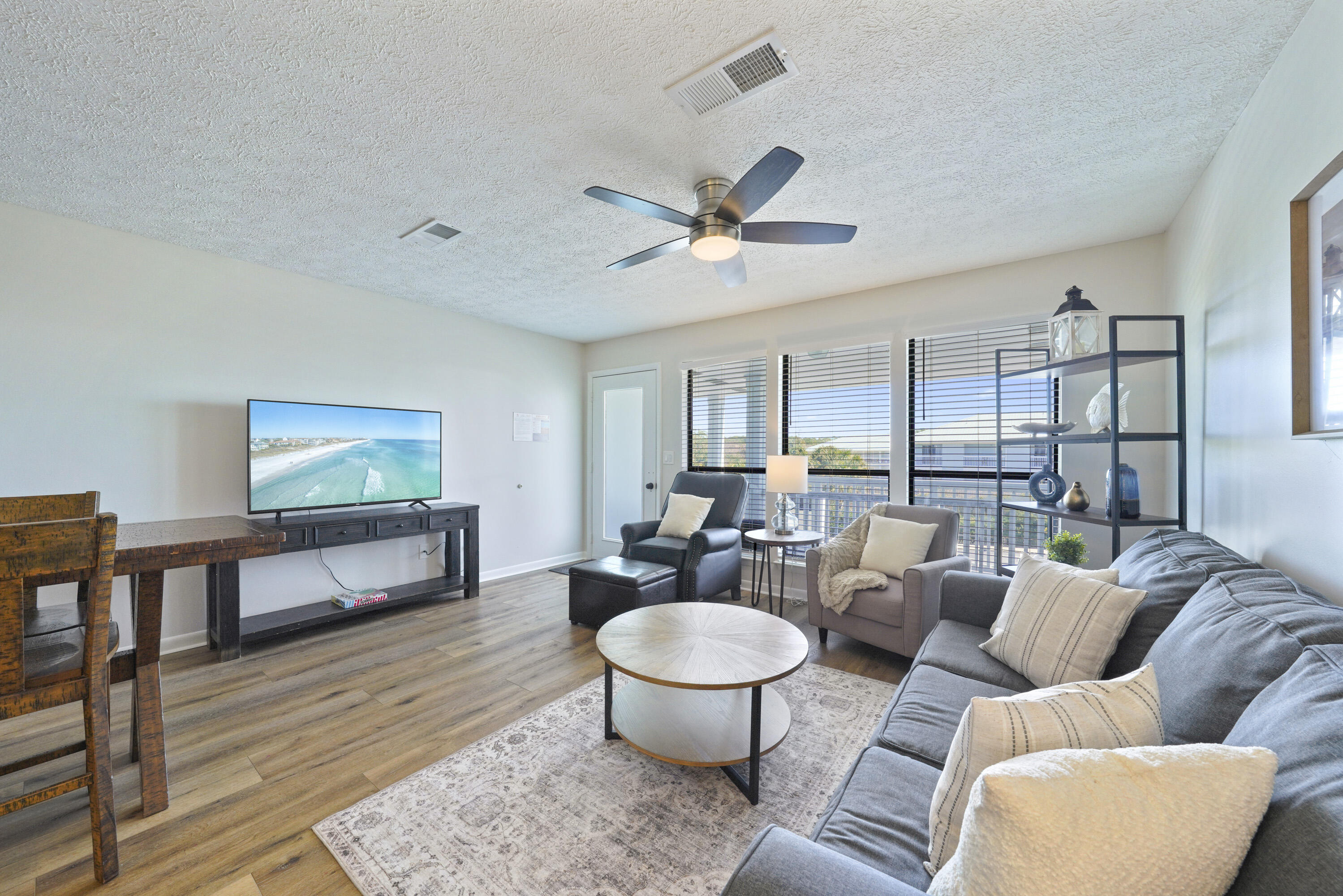 17670 Front Beach Road, Unit H9 Panama City Beach, FL 32413 - Photo 7 of 31 a living room with furniture and a wooden floor