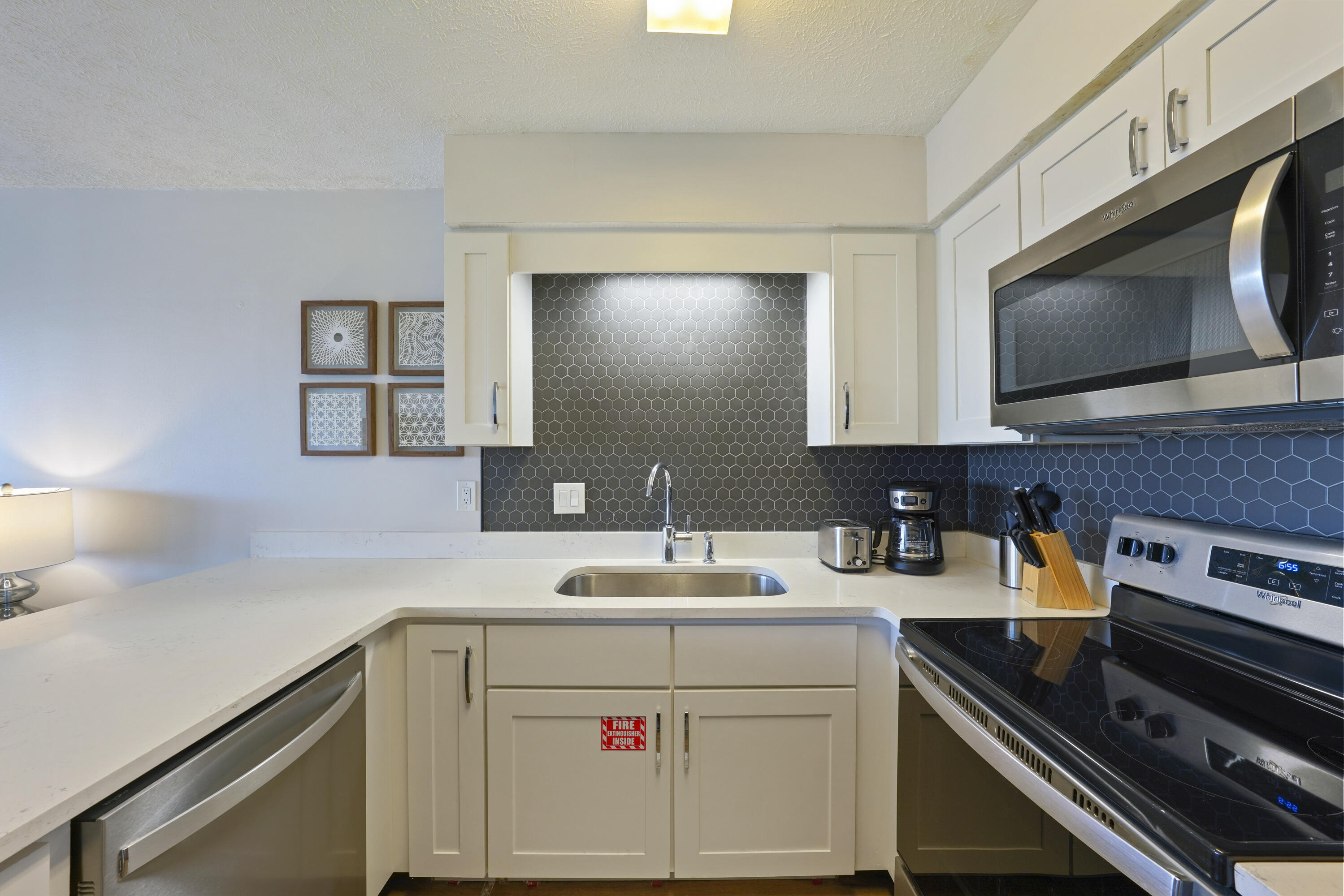17670 Front Beach Road, Unit H9 Panama City Beach, FL 32413 - Photo 10 of 31 a kitchen with a sink stove and microwave