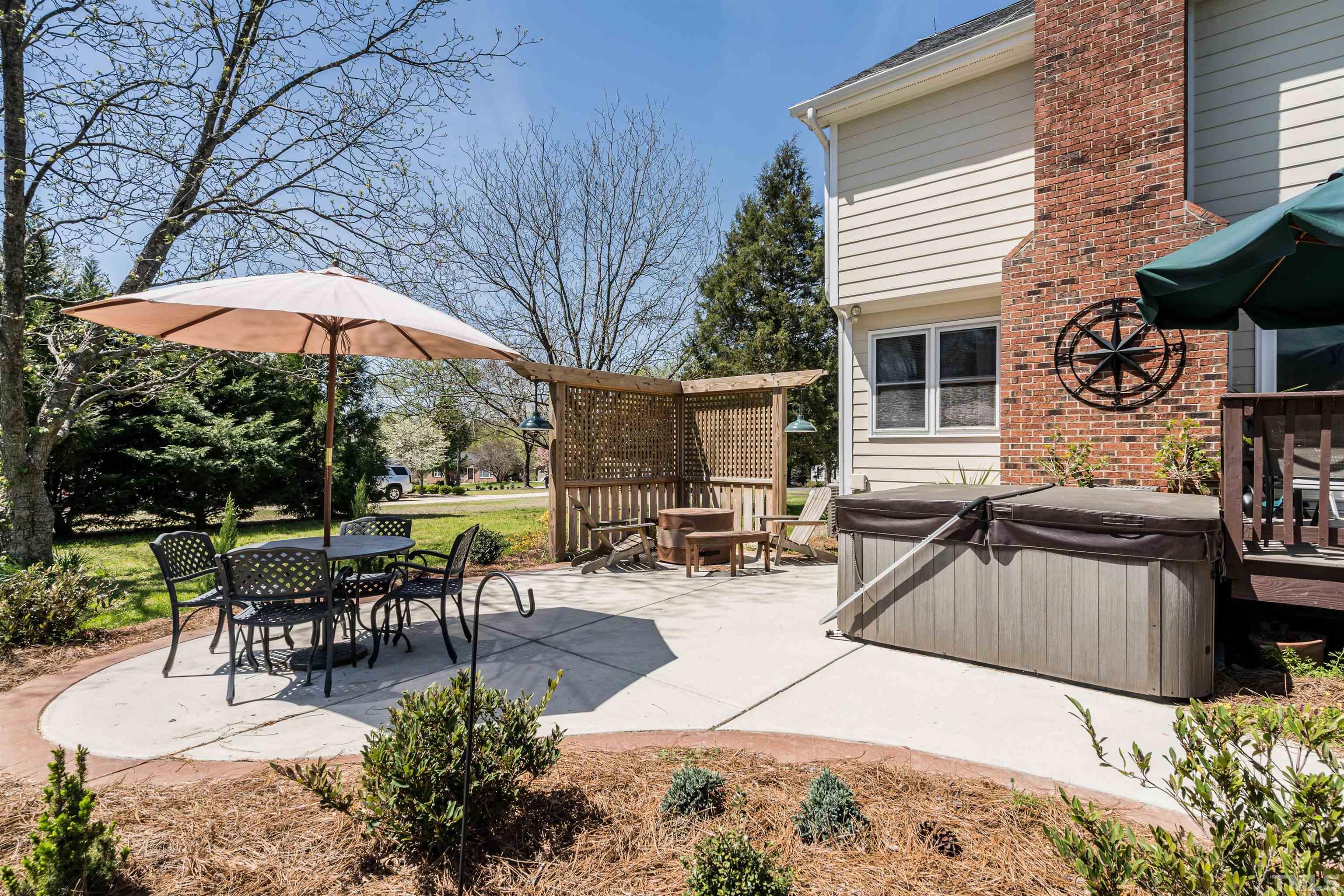5929 Hampton Ridge Road Raleigh, NC 27603 - Photo 23 of 27 a view of a patio with table and chairs under an umbrella