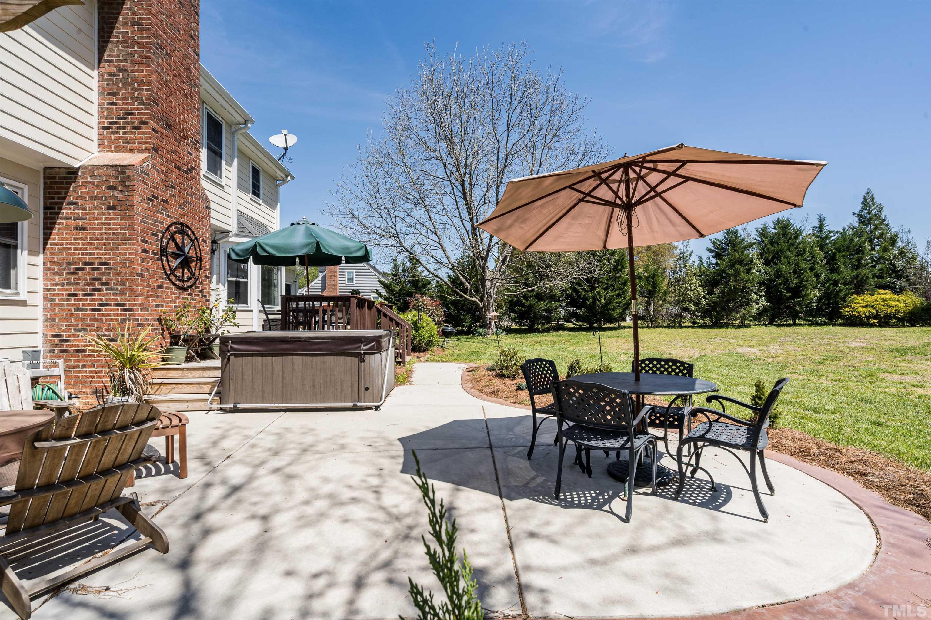 5929 Hampton Ridge Road Raleigh, NC 27603 - Photo 24 of 27 a view of a patio with a table and chairs under an umbrella