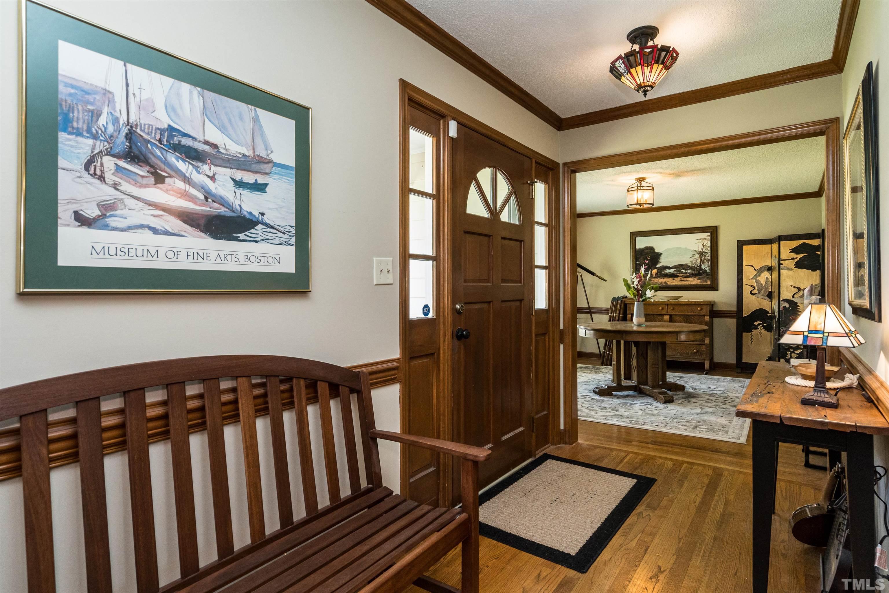 5929 Hampton Ridge Road Raleigh, NC 27603 - Photo 4 of 27 a view of a hallway with wooden floor and furniture